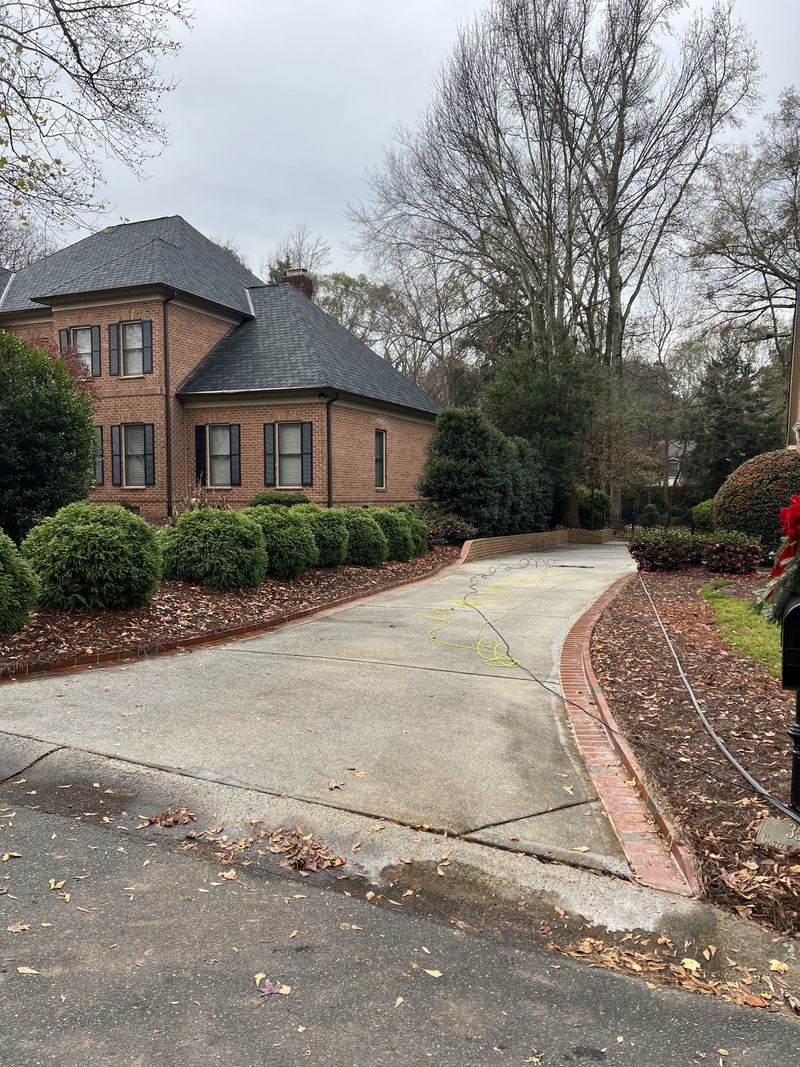 A long curved driveway, grey and stained