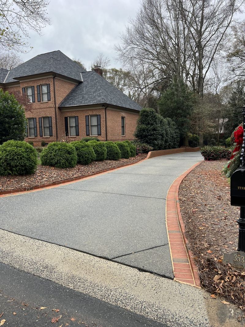 The same driveway after washing, clean to its brick edging
